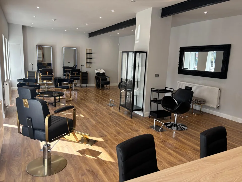 The light-filled Brown & Co salon in Thorne, with black styling chairs and wooden floors